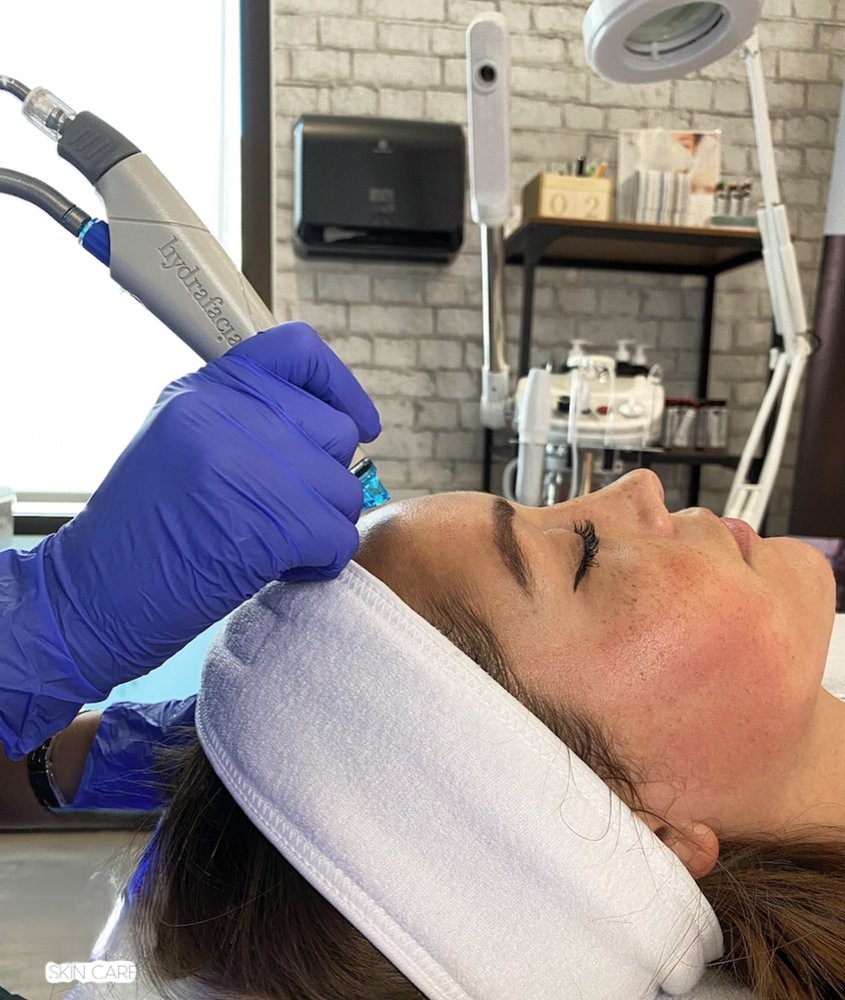 Letticia providing attentive skin care to a client